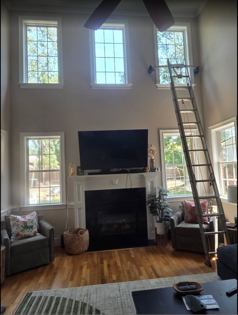 Two-story living room windows before and after interior ladder window cleaning, after cleaning